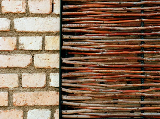 Detail Sichtmauerwerk aus Lehmziegelsteinen und Flechtwerk aus Papyrus