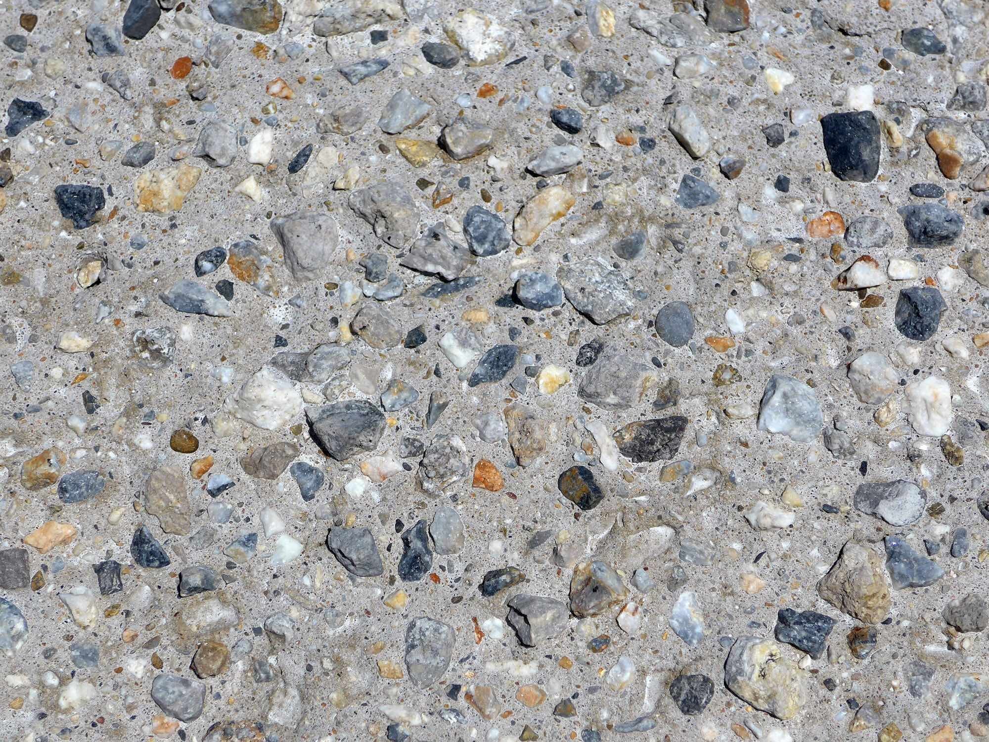 Freigelegte Gesteinskörnung zeigt das mineralische Gefüge eines verdichteten Betons.