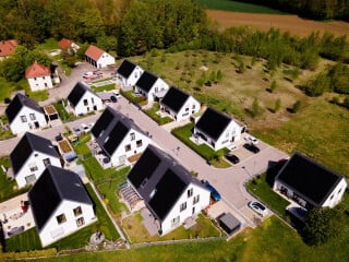 Die 13 Wohnhäuser der Effizienzhaus-Plus-Siedlung Hügelshart sind komplett im KfW-55-Standard gebaut. Alle Einheiten wurden mit einer Wärmepumpenheizung und einer PV-Anlage nebst Batteriespeicher versehen. Die Heizungsanlagen sind über ein Internet Service Gateway mit dem jeweiligen Heimnetzwerk im Gebäude verbunden. Projektbeteiligte: BayWa AG, asset bauen wohnen GmbH, BayWa r.e. und Stiebel Eltron. 