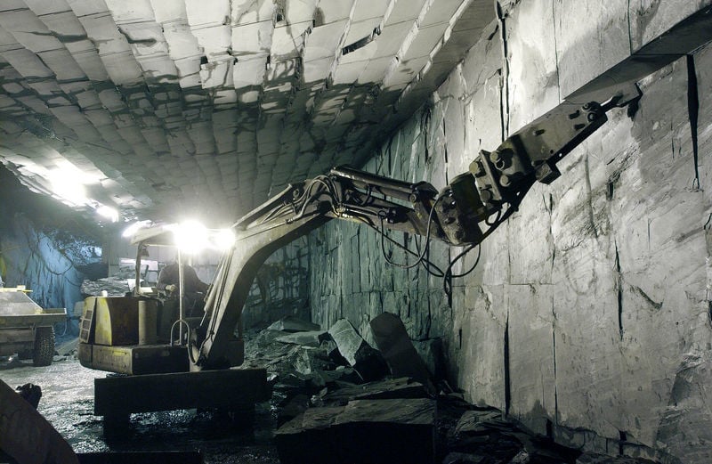 Der mit der Säge auf Blockgrößen von je einer Tonne vorbereitete Schiefer wird mittels großer gelenkgesteuerter Meißel aus dem Berg getrennt