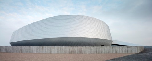 Die Aluminiumfassade wird ergänzt durch Wände aus Sichtbeton