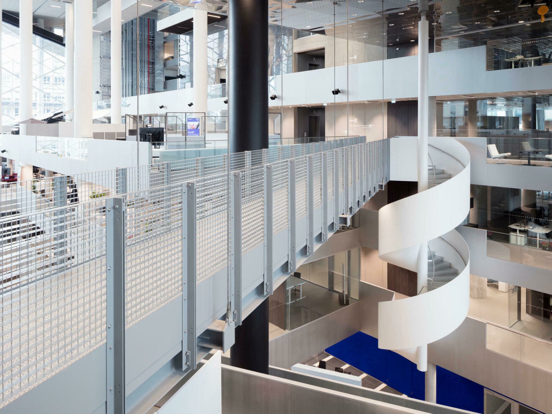 Spektakulär an einer Stange schwebend: Das ist die Spindeltreppe im Axel-Springerhaus, die eine Abkürzung zwischen den Geschossen und ein bisschen Sky-Walk-Gefühl bietet.