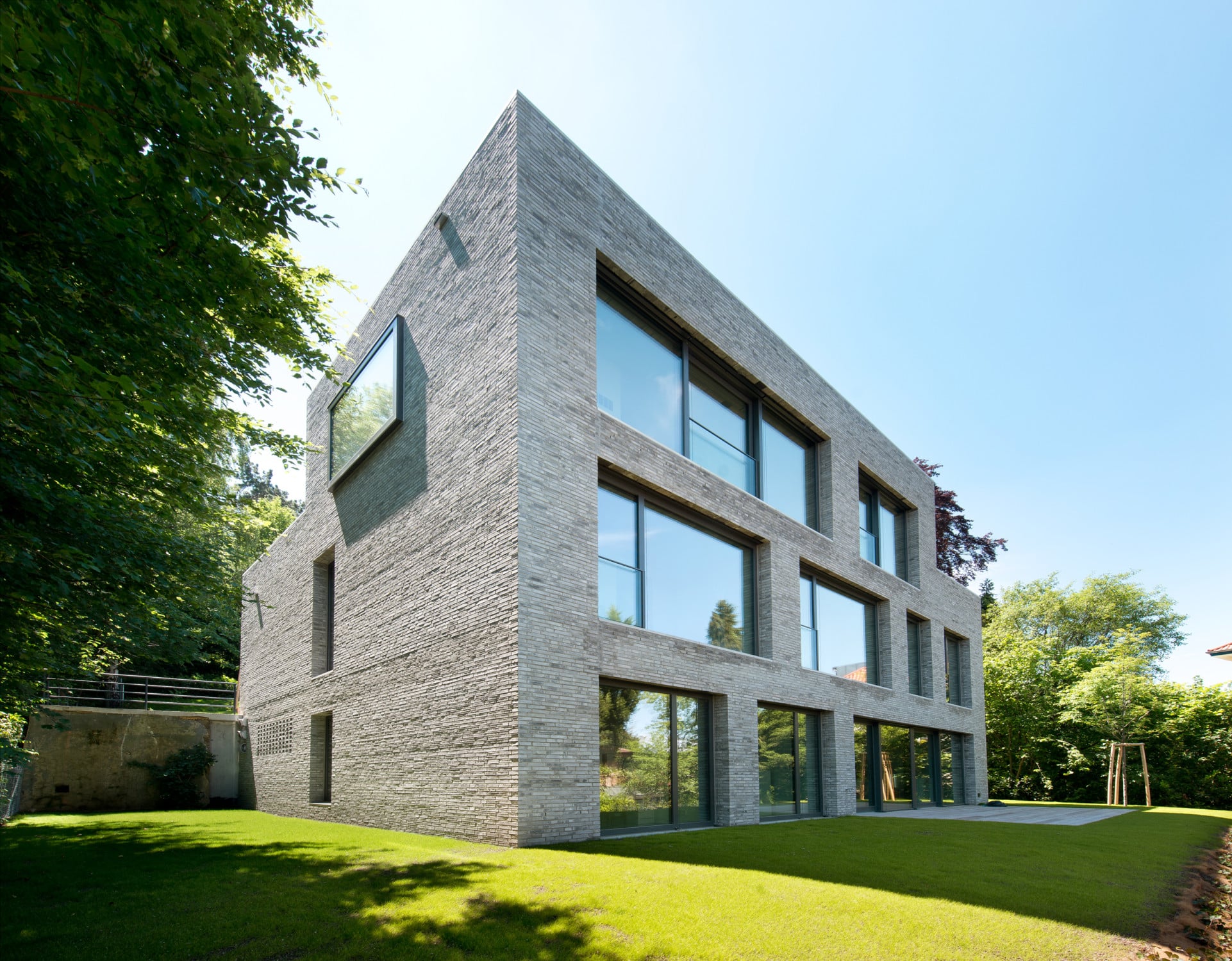 Nordostansicht: Talseitig ist die Fassade von den großen Fensteröffnungen geprägt, während die Stirnseiten eher geschlossen wirken
