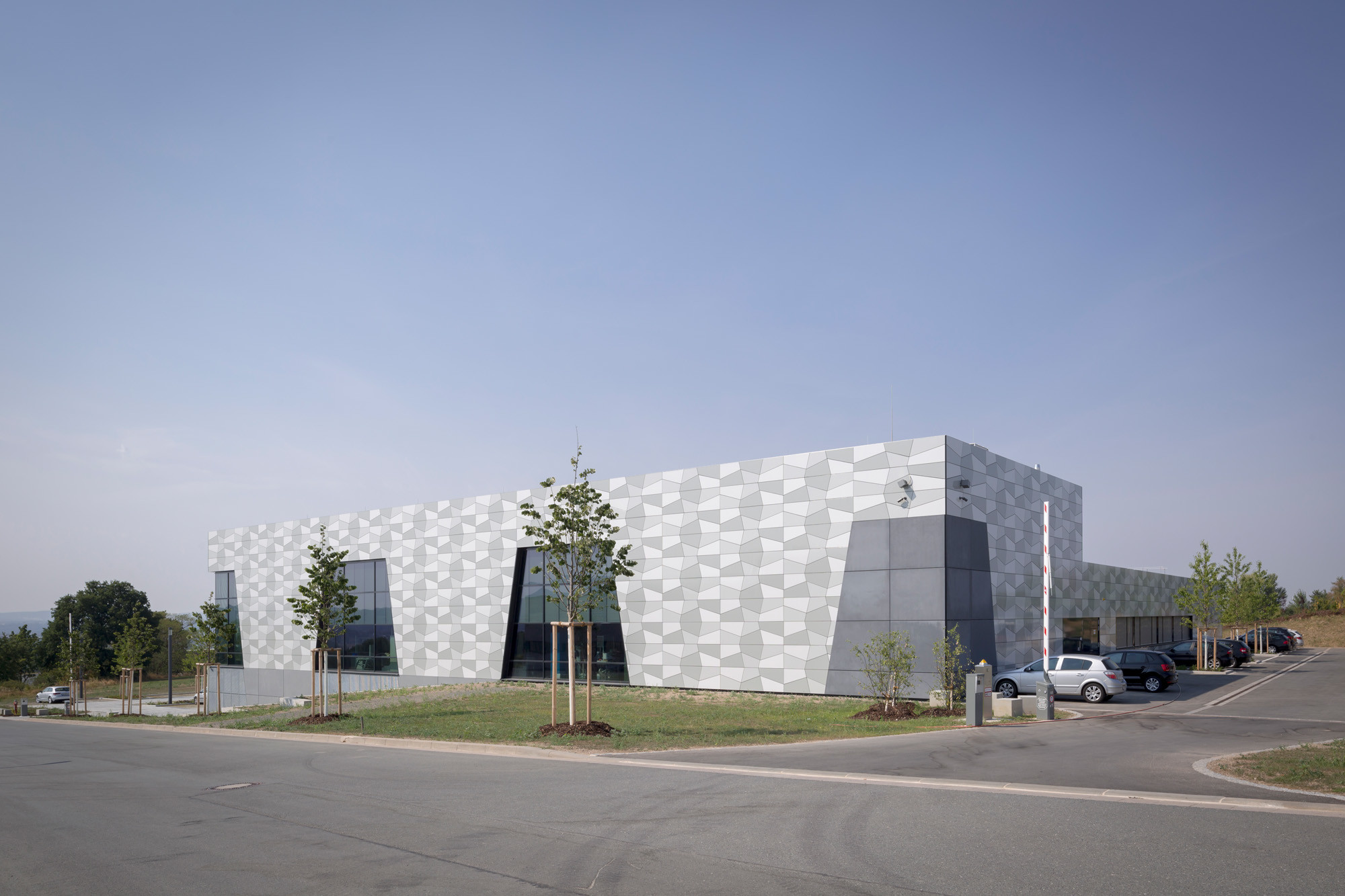 Der kompakte Laborbaukörper öffnet sich über Verglasungen, die wie Tore in die Fassade eingeschnitten sind (Nordostansicht)