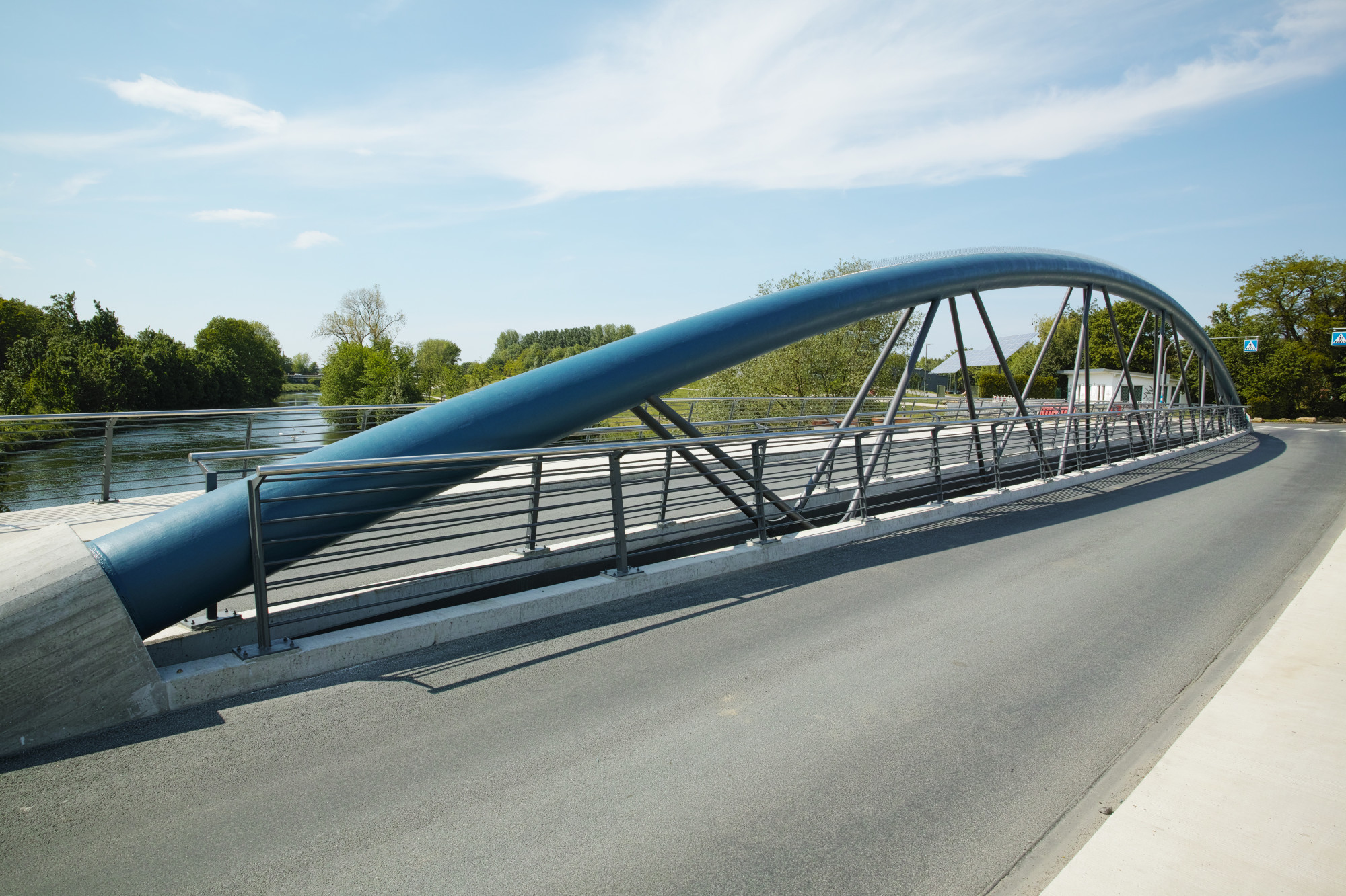 Der mittig zwischen den beiden Fahrbahnen platzierte, auffällige blaue Bogen trägt sein Eigengewicht und symmetrische Lasten