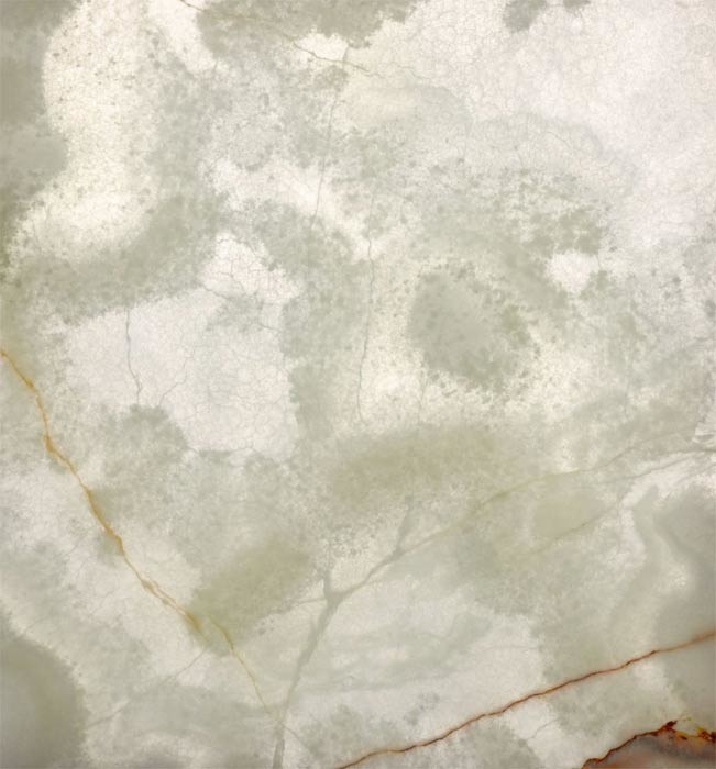 SGG Floatstone Onyx ist ein grün-gelblicher Naturstein mit oft großflächiger brauner Äderung