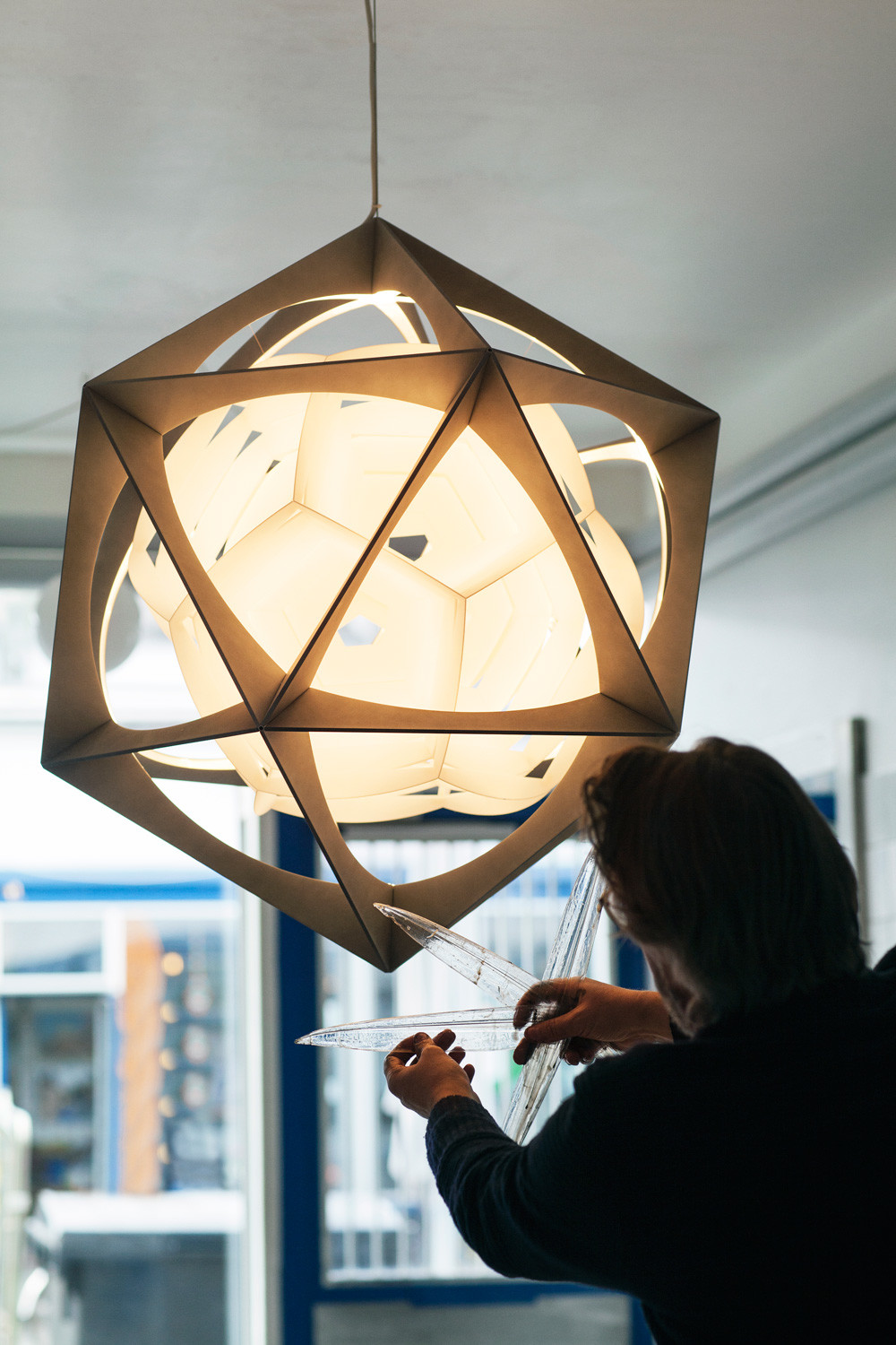 Die Leuchte besteht aus zwei ineinandergreifenden komplexen geometrischen Formen und ...