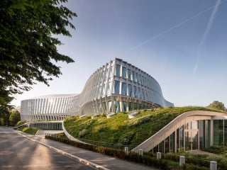 Der IOC-Hauptsitz von 3XN und Itten Brechbühl in Lausanne fällt durch seine geschwungene Doppelfassade aus Glas auf.