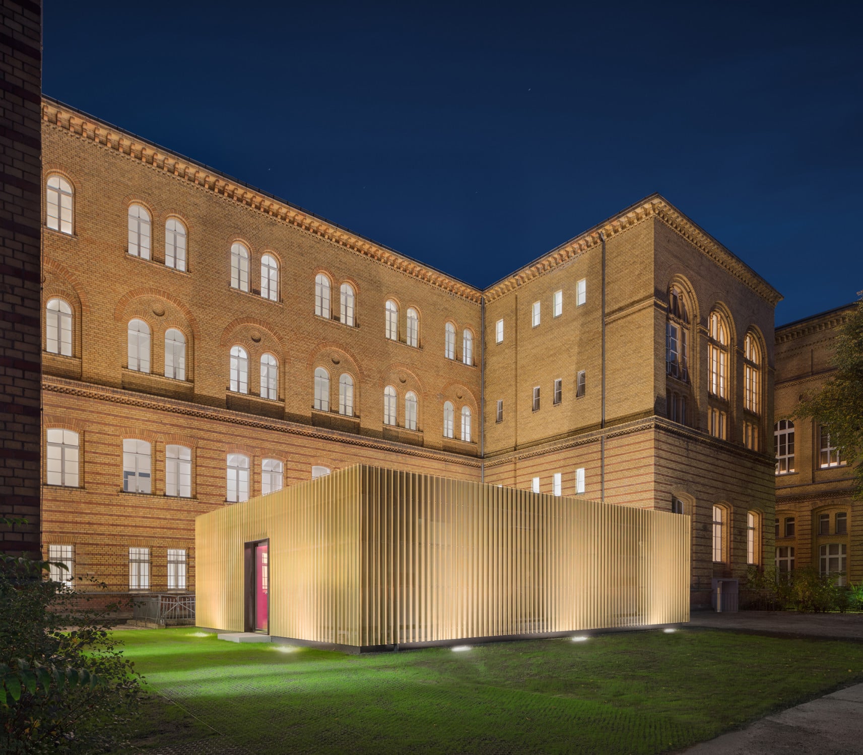 Zwei goldumhüllte Quader mit je sieben Räumen sind eingebettet in den straßenabgewandten Hof des historischen Bestandbaus. Sie bieten als schallentkoppelte Boxen nun Platz zum ungestörten Proben (im Bild: die nördliche Box).