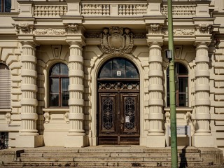 Mittelrisalit mit zwei Turmaufsätzen, dreiteilige Staffelung in Sockel, Bel Etage und Aufsatz, Oper in Zagreb, 1895 von den Wiener Architekten Ferdinand Fellner und Herman Helmer erbaut. Als "Logo-Farbe" ist das Gebäude in Habsburgergelb gestrichen, genau wie das Schloss Schönbrunn, in dem der Kaiser von Österreich-Ungarn residierte. Die Eingangstür ist exakt in der Mittelachse der Schaufassade. 