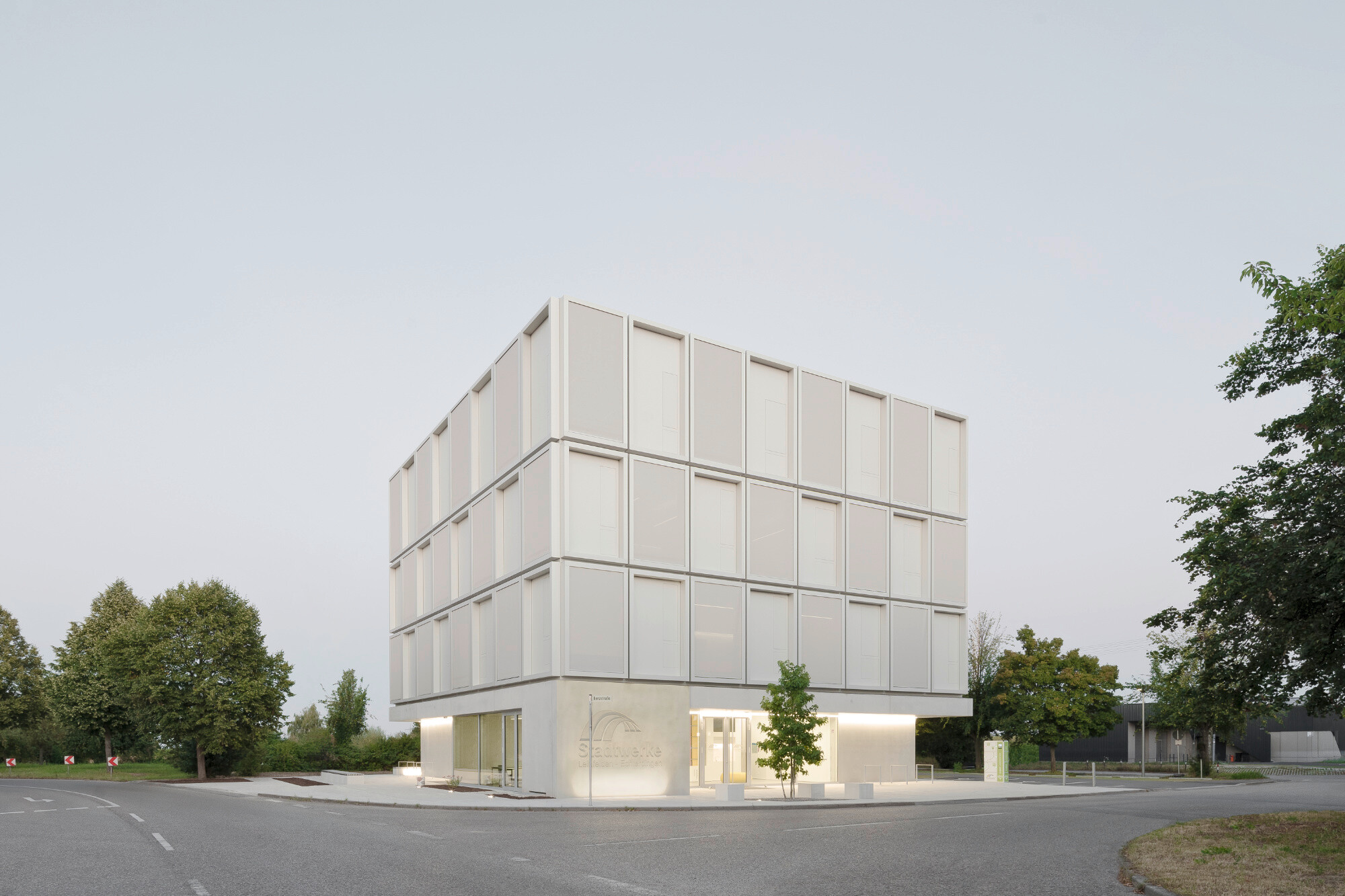 Die geschlossenen Wandbereiche der Erdgeschossfassade sind mit vorgehängten Betonfertigteilen verkleidet.