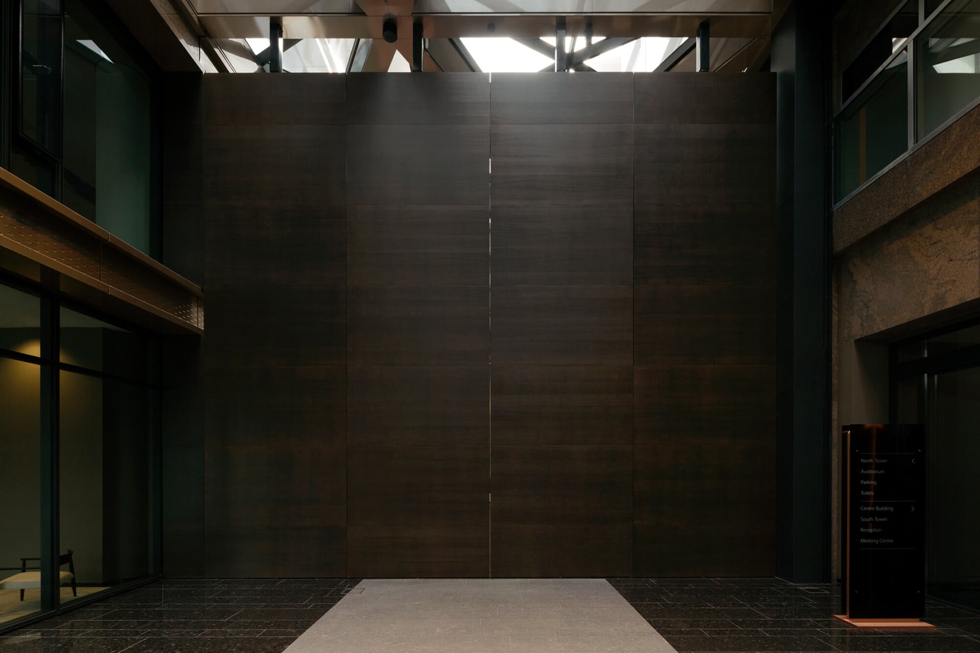 Die Türblätter können Höhen bis zu 6 m und Breiten bis zu 3 m aufweisen, also weit größer als herkömmliche Türblätter sein (im Bild: geschlossener Zustand einer Aluminium-Holz-Pivot-Tür in einem Atrium in Amsterdam).