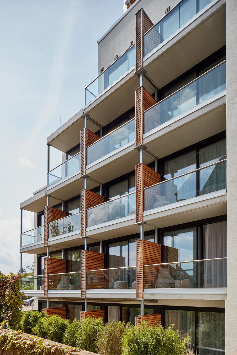 Für das Erscheinungsbild – hier der nordwestlichen Fassade – sind die Materialien Beton, Glas und Holz bestimmend..