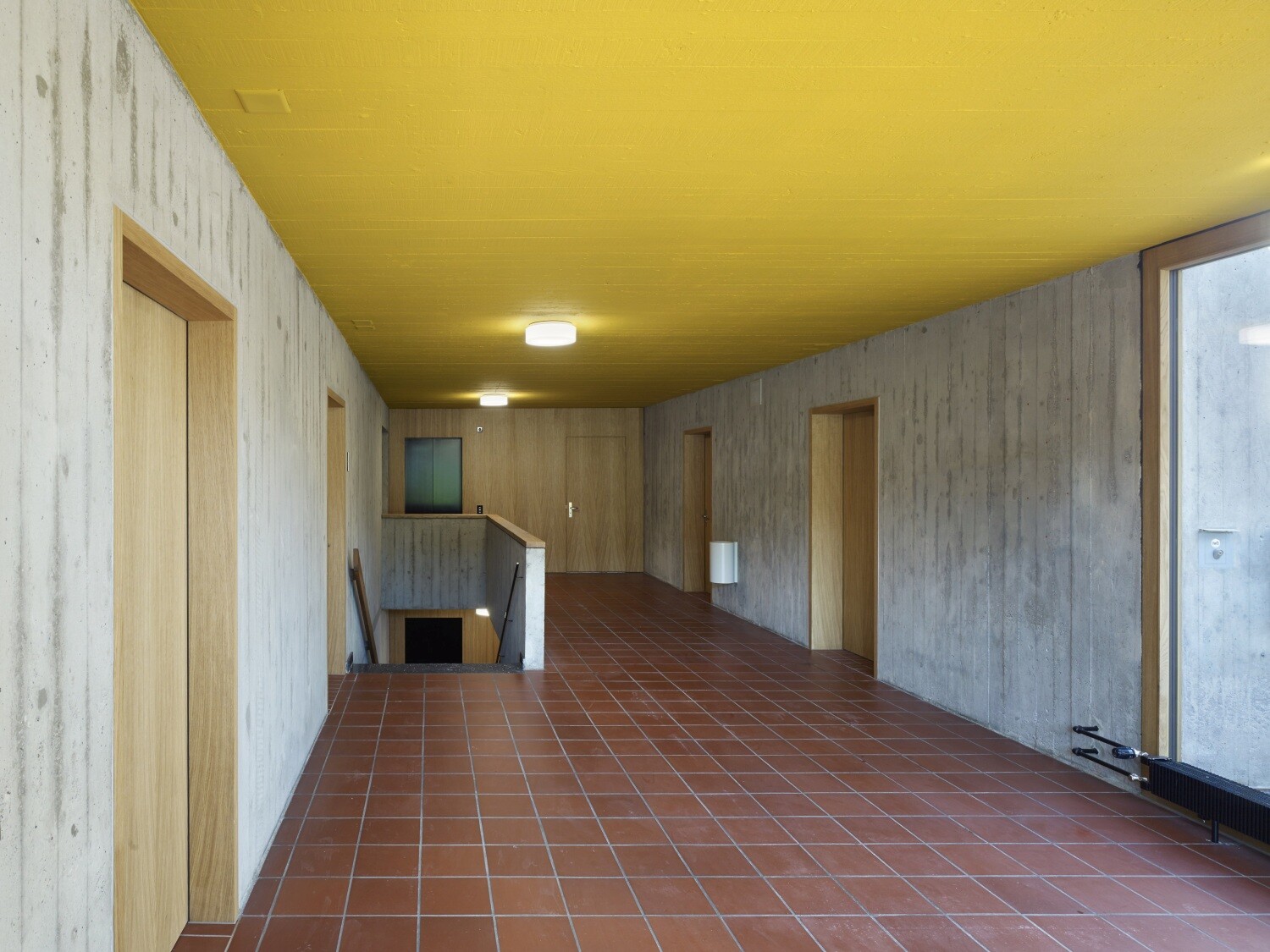 In der Eingangshalle erhielt die niedrige Betondecke einen warmen Gelbton, wie in der originalen Farbpalette festgelegt.