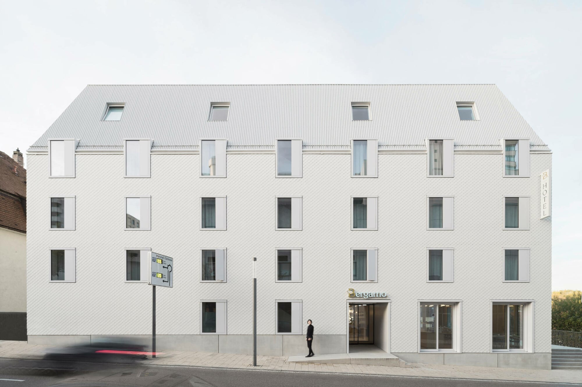 Der schlichte Fünfgeschosser des Stuttgarter Architekturbüros VON M mit gekapptem Mansarddach lehnt sich in seiner Gestalt und Konstruktionsweise an Wohnhäuser aus dem 18. Jahrhundert an, ohne sie zu imitieren.