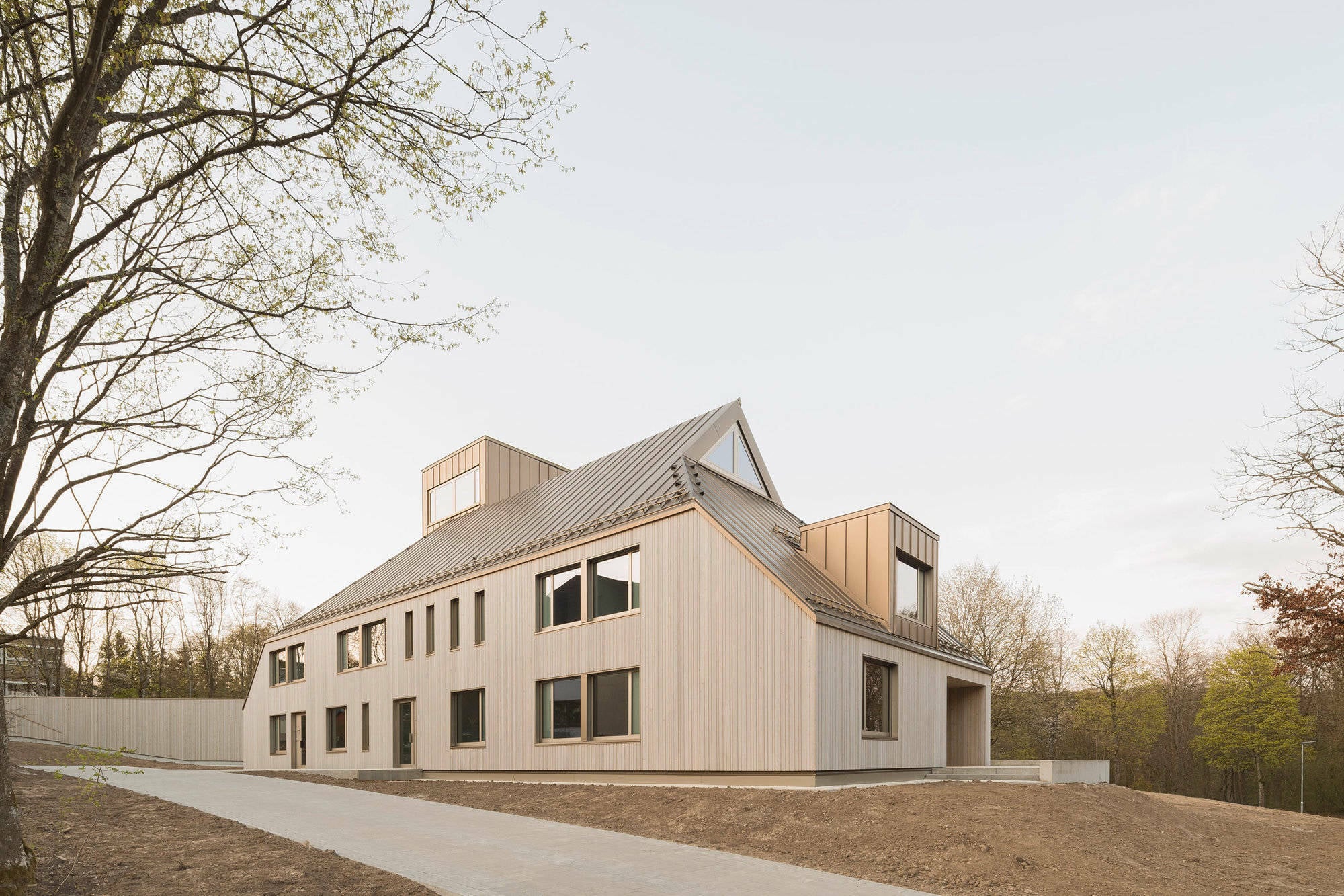 Die Neubauten ergänzen die vorhandenen Wohngebäude, Schul- und Freizeiteinrichtungen und Ferienhäuser sowie das Tagungshaus und die Kirche mit Festsaal.