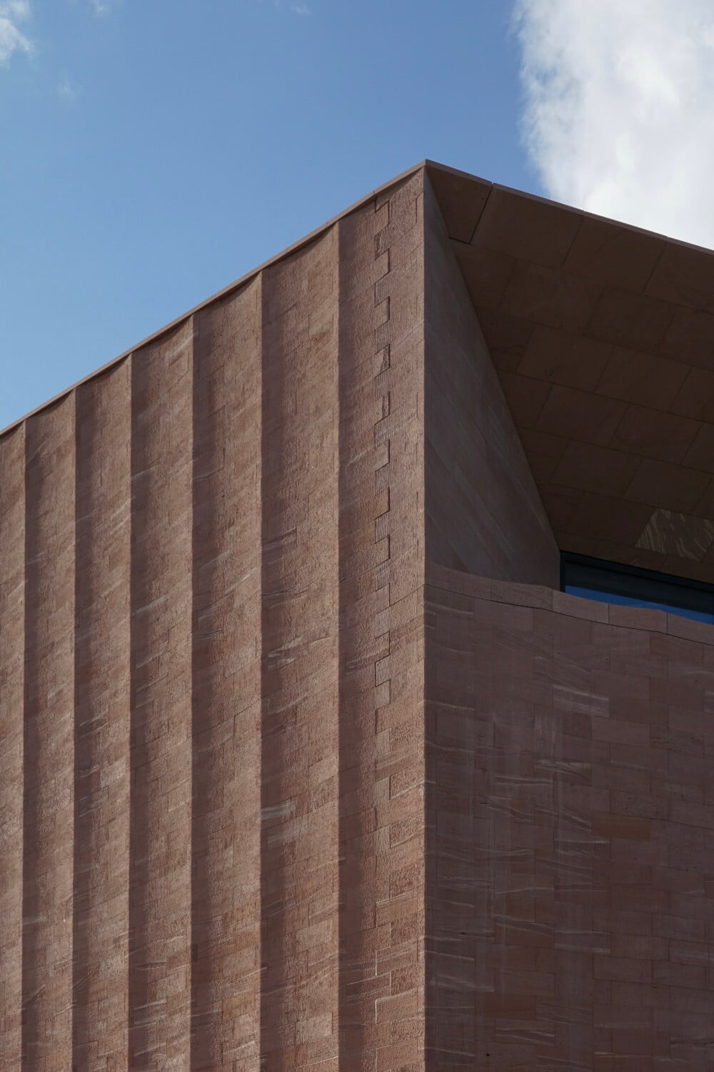 An einigen Stellen erinnert die Fassade an einen mächtigen Bühnenvorhang.