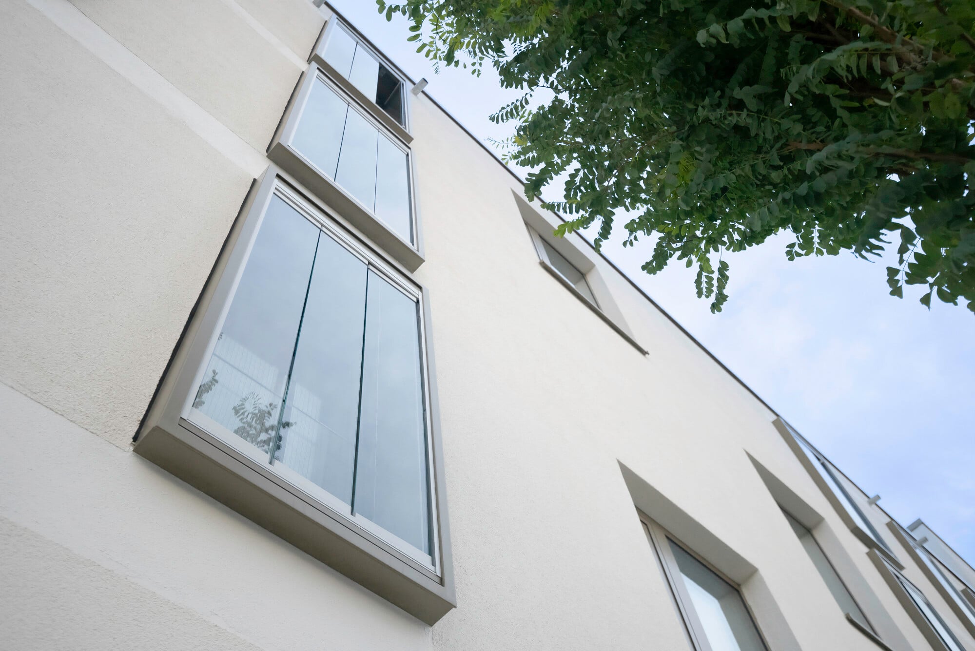 Nach außen schließt das Kastenfenster mit drei ebenfalls raumhohen Dreh-Schiebe-Elemente aus dem System Solarlux SL 25 ab.