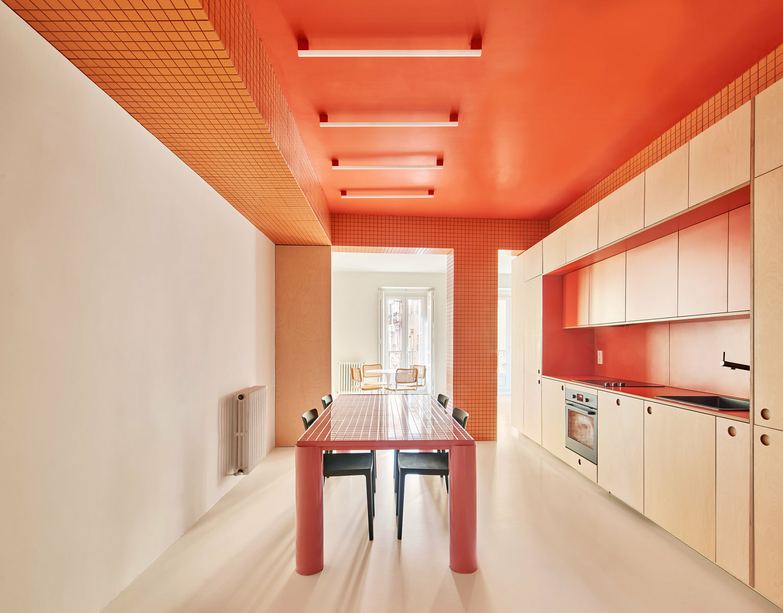 Extraordinär ist das neue Zuhause: Kräftiges Orange, poppiges Pink und knalliges Gelb dominieren die minimalistisch möblierten Räume. 