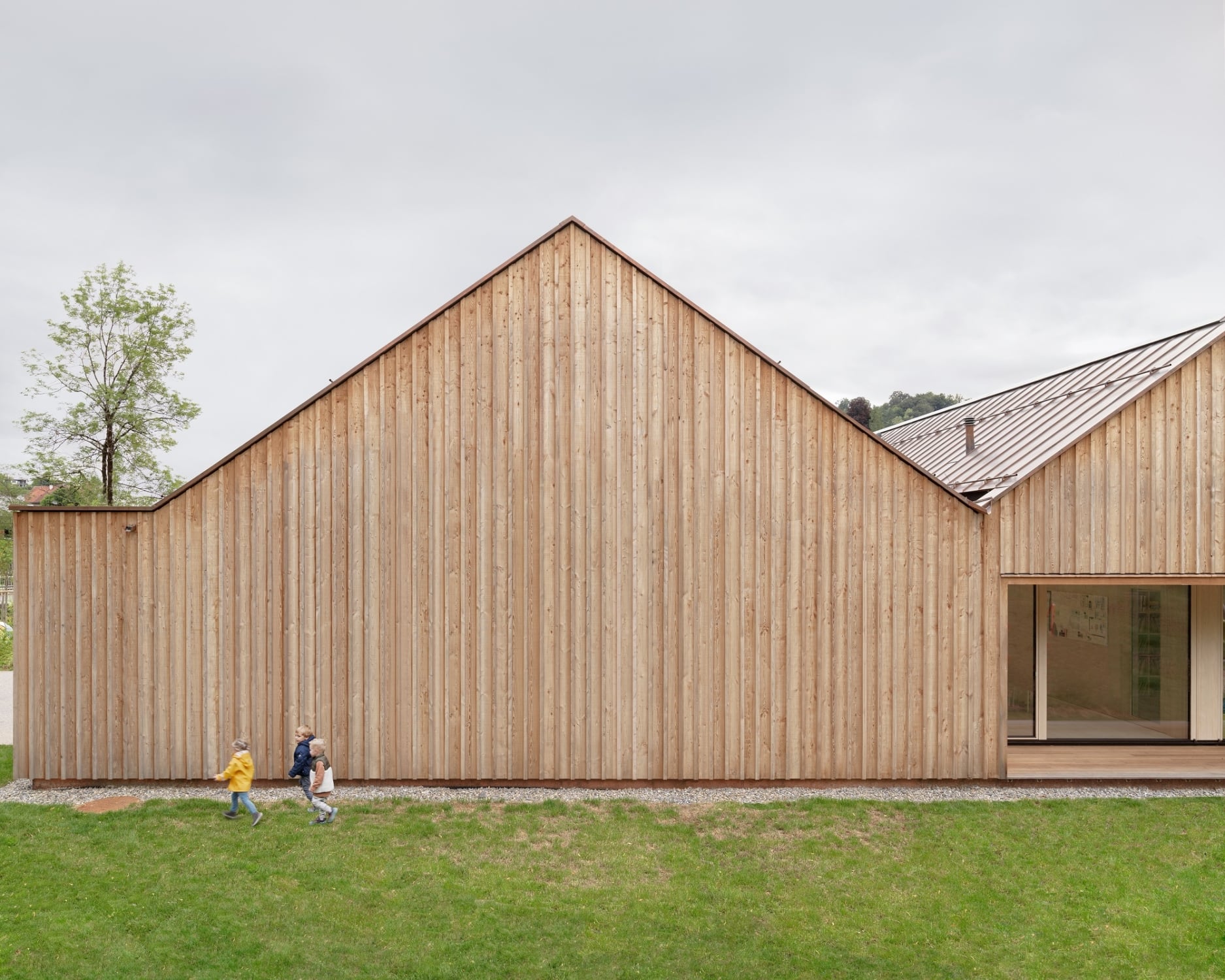 Die Fassade bildet eine hinterlüftete Holzschalung aus witterungsbeständigem, unbehandelten Lärchenholz.
