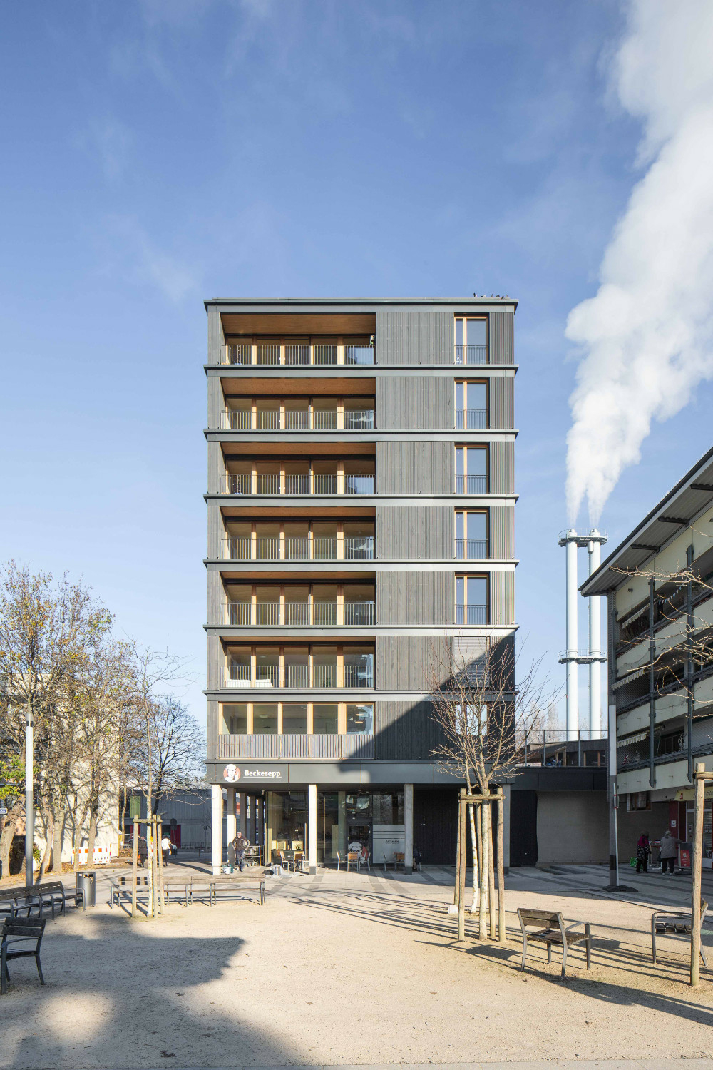Blechschürzen gliedern die Fassade, um im Brandfall einen Überschlag der Flammen von einem Geschoss ins nächste zu verhindern.