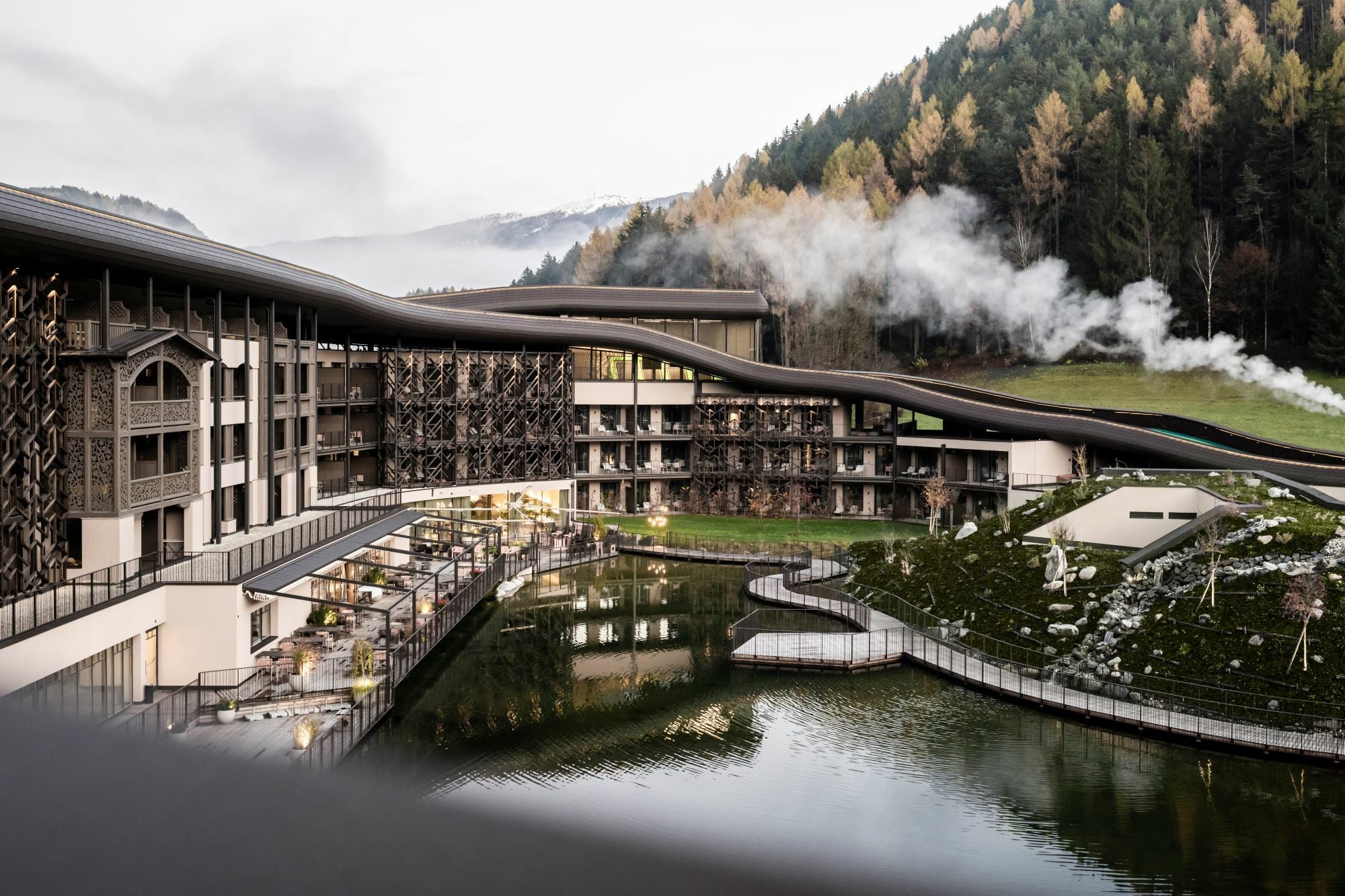 Wellenartig schmiegt sich die Dachkonstruktion in die alpine Umgebung ein.
