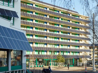 In Zürich haben Donet Schäfer Reimer Architekten zwei achtgeschossige Wohnscheiben mit PV-Modulen an den Laubengangbrüstungen geplant.