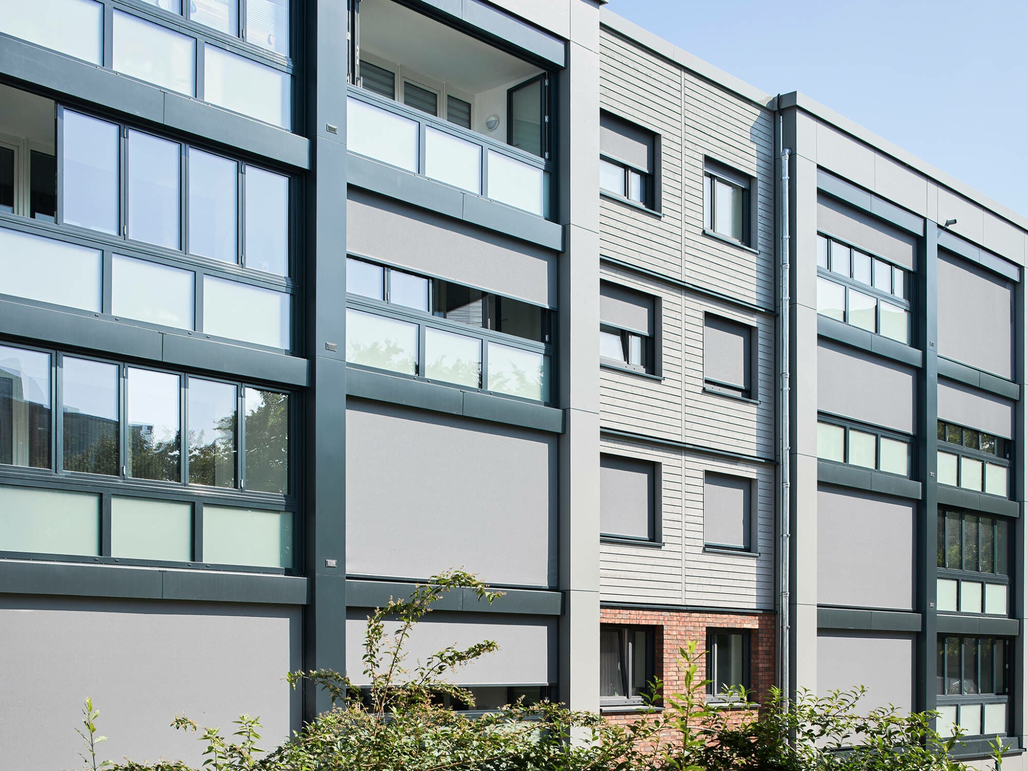 Vorgehängte Falt-Schiebe-Fenster aus Aluminium von Schüco werten die Loggien im Düsseldorfer Corelli-Quartier zu ganzjährig nutzbarem Wohnraum auf und stellen die Förderfähigkeit des Projekts sicher. 