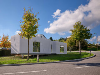 Das Tiny House LUX von ODA Architects nutzt eine schmale Restfläche an einer Straßenkurve in Niederanven.