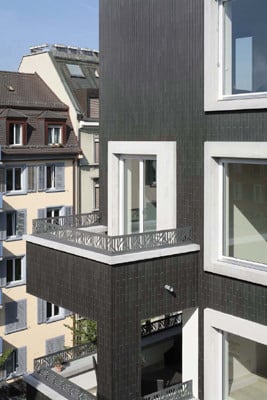Übereinander liegende Balkone werden von der Fassade zusammengefasst