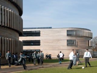 Das rötliche Holz prägt die Außenfassade der Schule